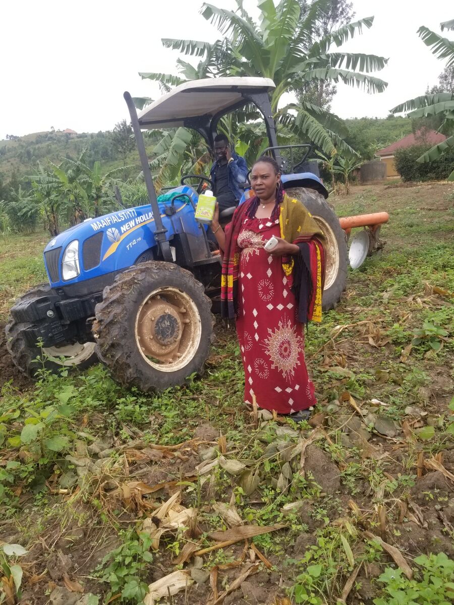 Farmer holding Nutriplant Organic Plus Fertilizer bottle in the garden